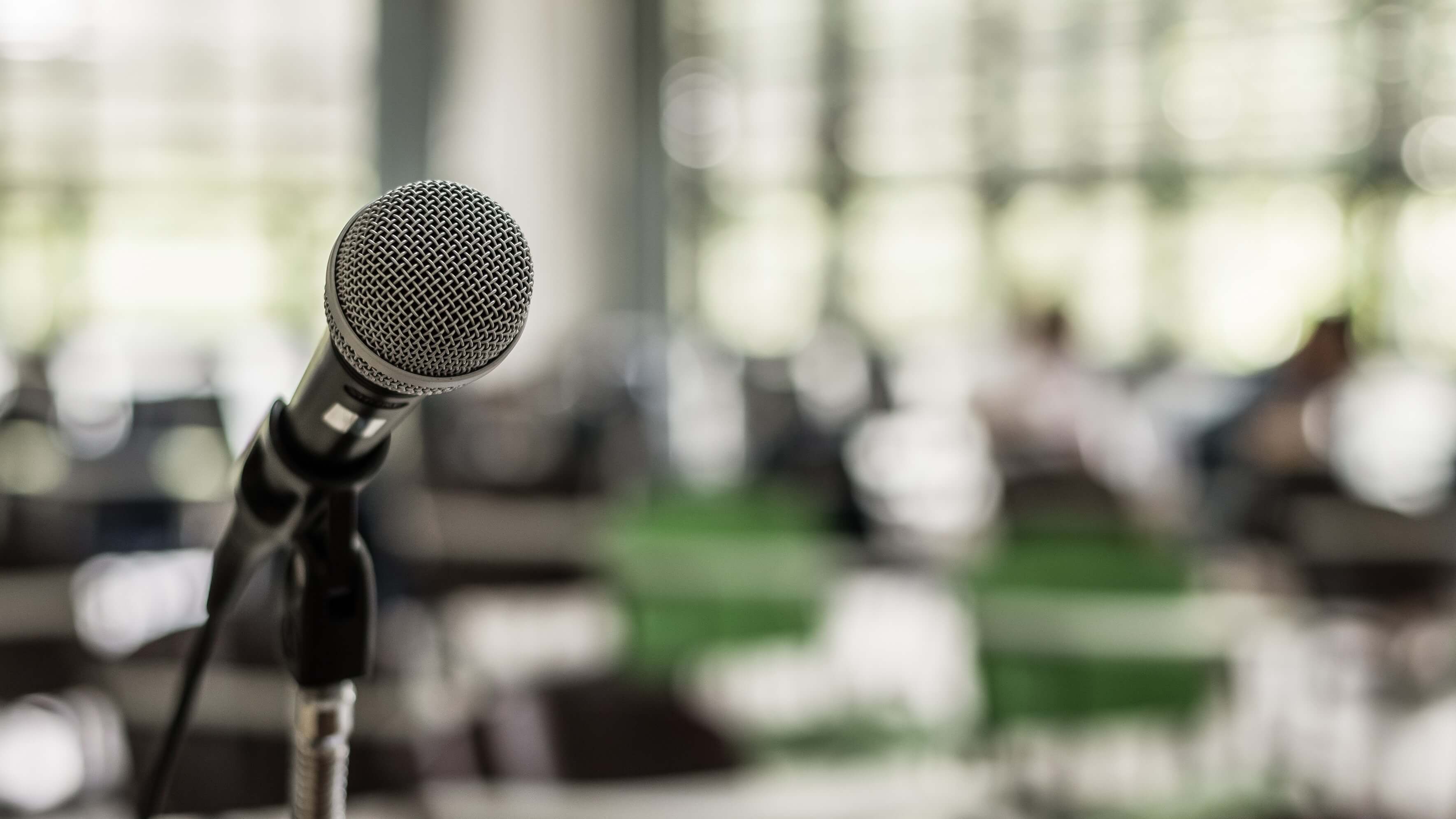 Microphone on a stand in the front of a large room