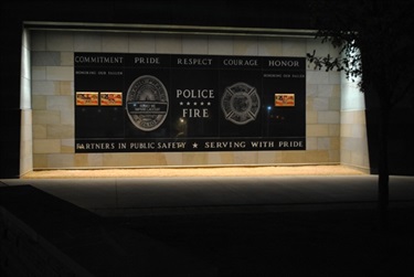 Police Headquarters - At the entrance to the new Public Safety Building, 1525 Arkansas Lane, a large inlaid black granite sculpture honors our fallen police and fire, proclaims the values of the departments and displays the badges of Fire and Police in etched stone. It was designed with input from police officers and firefighters.