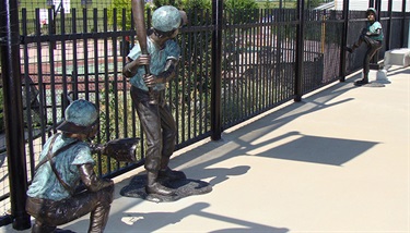 Baseball Boys - Boys and baseball...forever the two are enshrined in bronze in this delightful three-piece bronze featuring a catcher, hitter and pitcher at QuikTrip Park, home of the Grand Prairie AirHogs minor league baseball team.