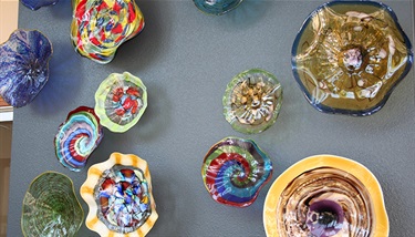 Glass Art - Glass is the finest piece of art that you can add to your home or office. Each piece in the arrangement in the city’s Human Resources Annex, 318 W. Main St., was uniquely hand blown to create an array of color and motion. These bowls were formed by a group of artisans from the northwest United States heavily influenced by the glass of Murano, Italy.