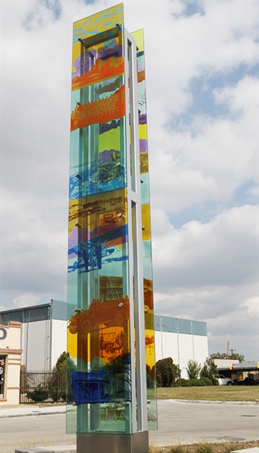 Colorful History - Colorful History is a one-of-a-kind sculpture composed of glass and steel. Glass panels are used to display a city timeline featuring a representation of Grand Prairie throughout the decades beginning with the frontier Days until now. It is located at 501 W. Main Street next to the new Fire Station #1.