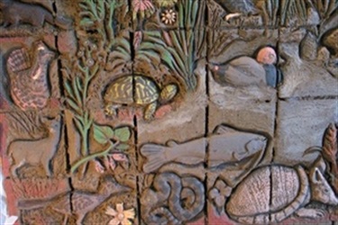 Prairie Paws Adoption Center Art - A seven foot by seven foot bas-relief sculpture in brick including color glazing features a prairie scene bordered with individual plants and animals, on display in the lobby of Prairie Paws Adoption Center. Installed in 2003 when Prairie Paws was a new facility, the artwork cost just under $25,000 and was paid for by private donations and a contribution from the Grand Prairie Facilities Sports Corporation.