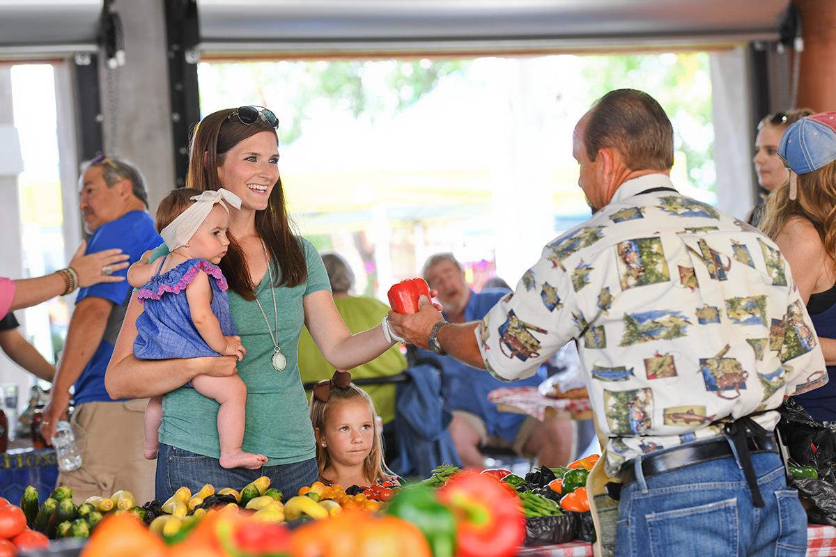 A woman and her baby shopping at the Farmers Market