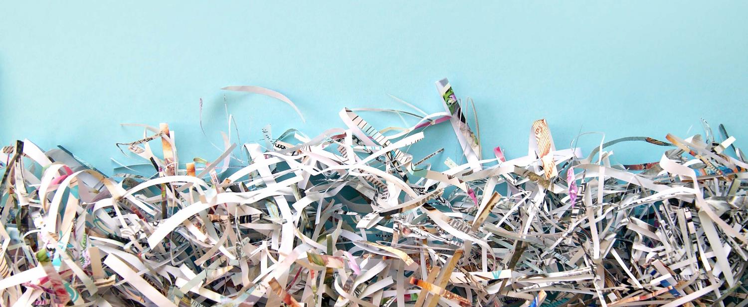 Shredded paper against a blue background