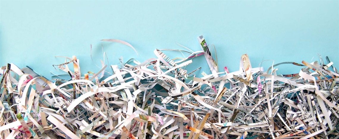 Shredded paper against a blue background