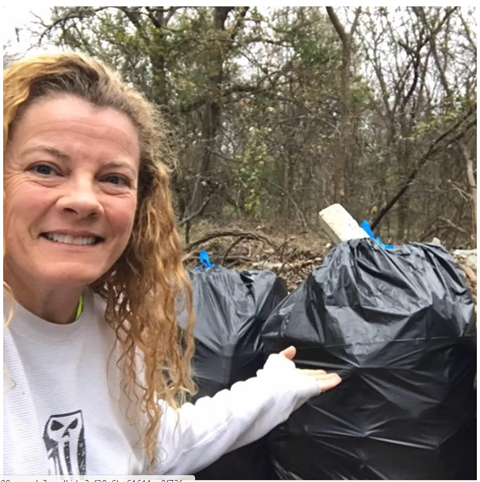 Angel Carter next to bags of trash