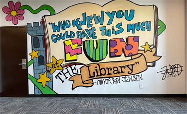 Main Library: During the Main Library’s 2024-2025 lobby remodel project,  artist and library employee James Franklin created an eye-catching mural. The mural is based on words spoken by Mayor Ron Jensen at an outdoors bubble event at the Warmack Library: “Who knew you could have this much fun at the Library?” Franklin, a Library Outreach Coordinator, created an original piece, drawing from the magic and imagination found in books.