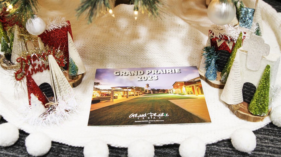 2023 Grand Prairie calendar sitting under a Christmas tree
