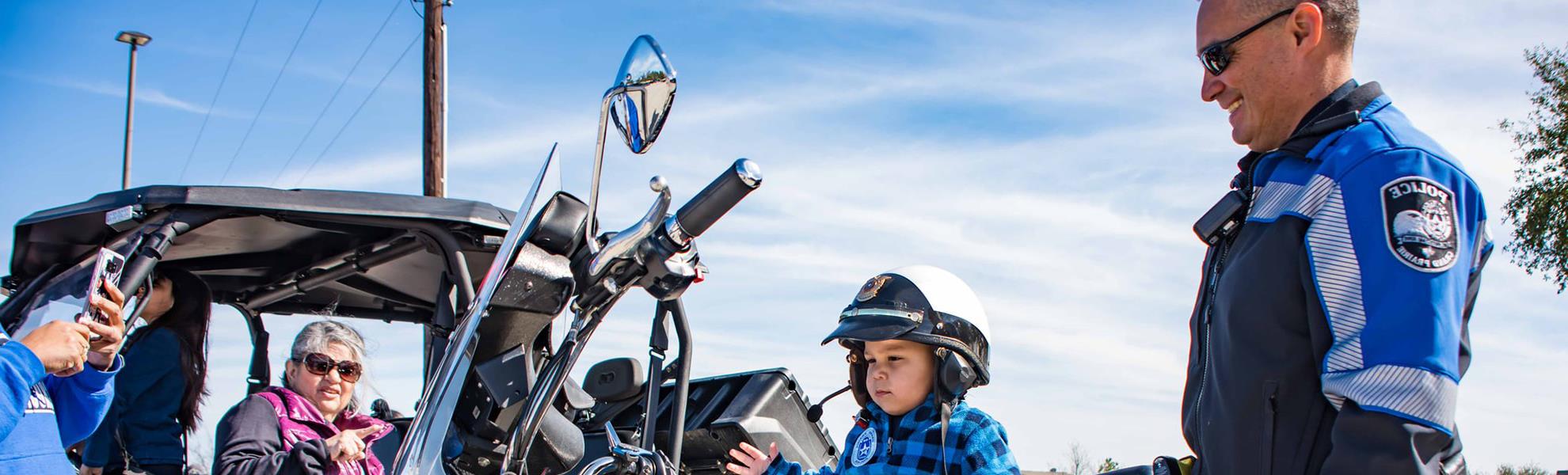 kid on police motorcycle